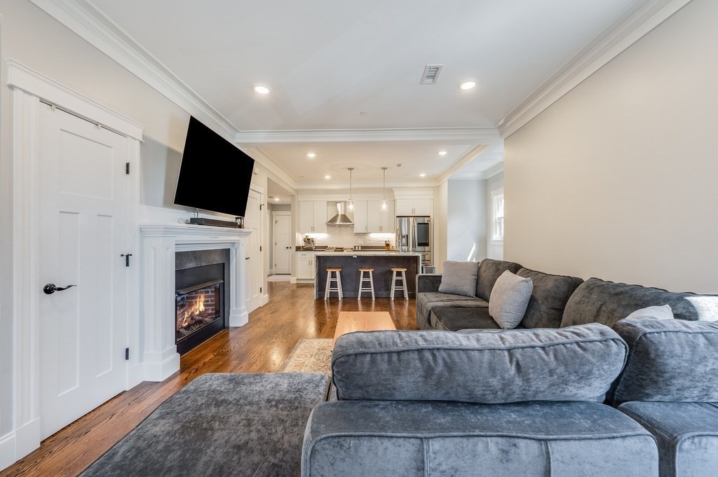 11 Preston Road, Unit 2 Somerville, MA 02143 - Photo 8 of 30 a living room with fireplace furniture and a flat screen tv