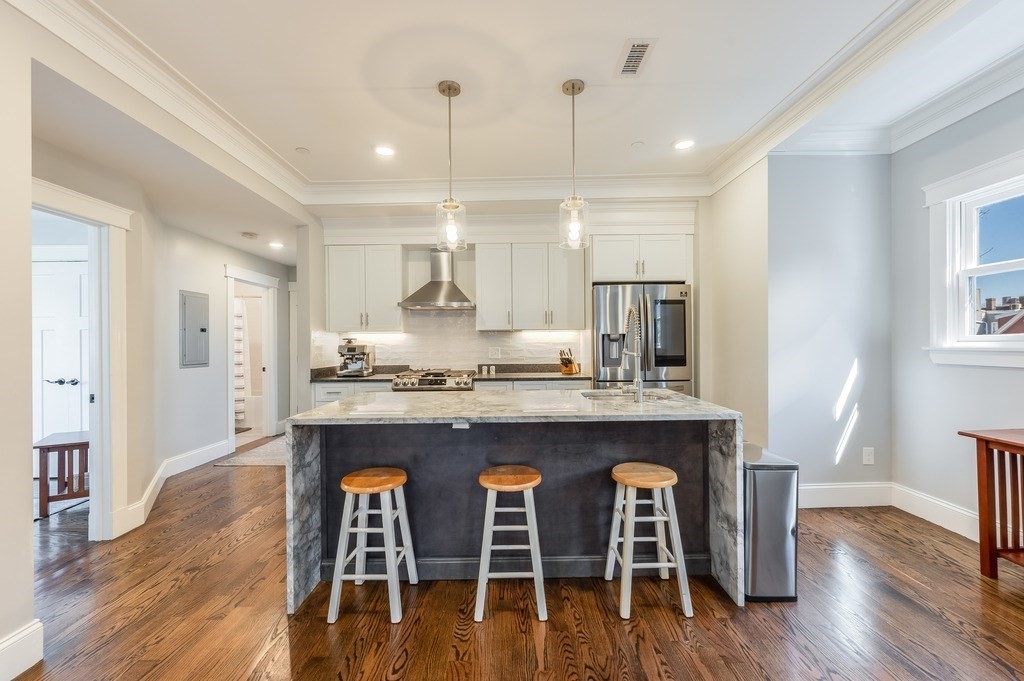 11 Preston Road, Unit 2 Somerville, MA 02143 - Photo 9 of 30 a large kitchen with a table and chairs in it