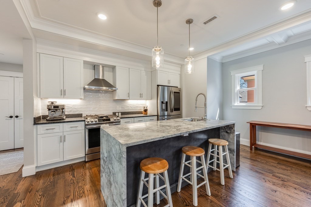 11 Preston Road, Unit 2 Somerville, MA 02143 - Photo 10 of 30 a kitchen with stainless steel appliances granite countertop a stove a sink and a refrigerator