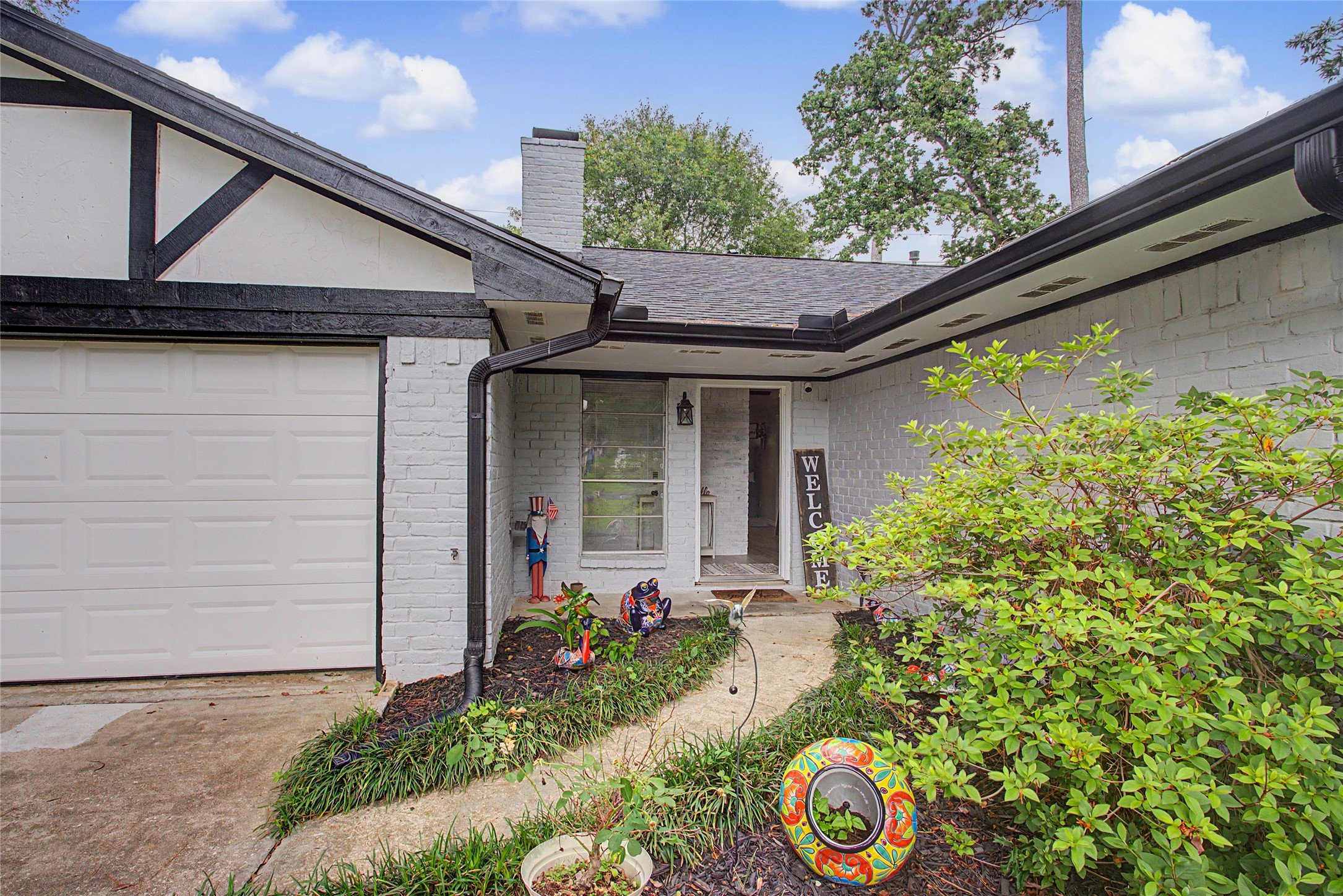 327 Fir Ridge Drive Huffman, TX 77336 - Photo 4 of 25 Lush landscaping greets you in front!
