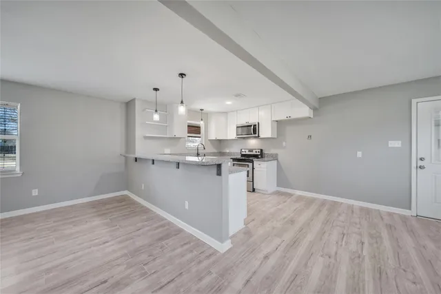 a view of kitchen with wooden floor