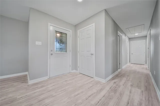a view of hallway with wooden floor