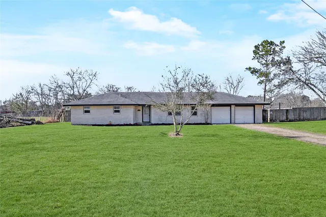 a view of a house with a yard and sitting area