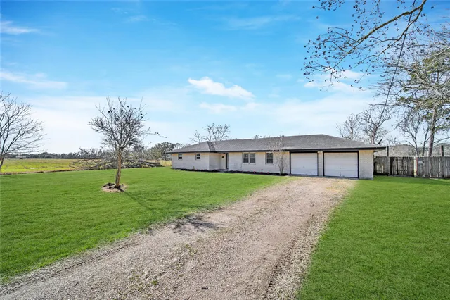 a view of a house with a backyard