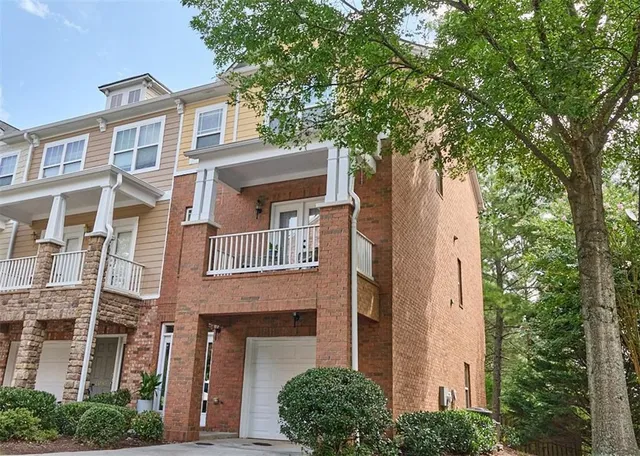 a front view of a building with a tree