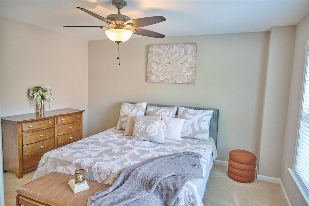 14183 Yacht Terrace Alpharetta, GA 30004 - Photo 25 of 30 a bedroom with a bed and a chandelier