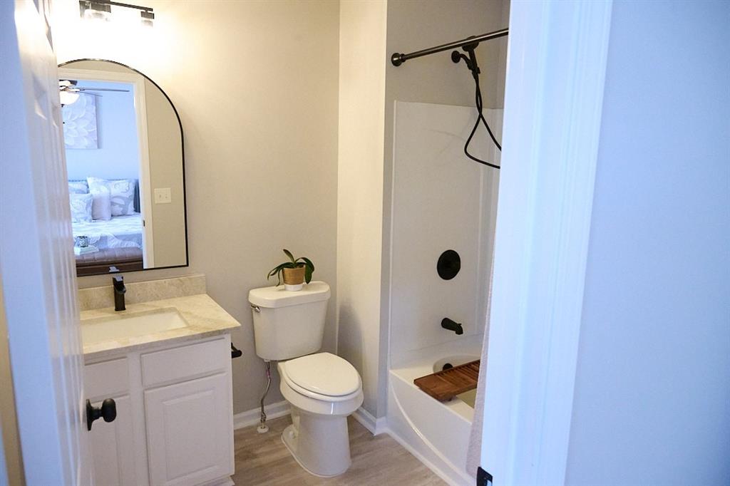 14183 Yacht Terrace Alpharetta, GA 30004 - Photo 26 of 30 a bathroom with a granite countertop sink a toilet and shower