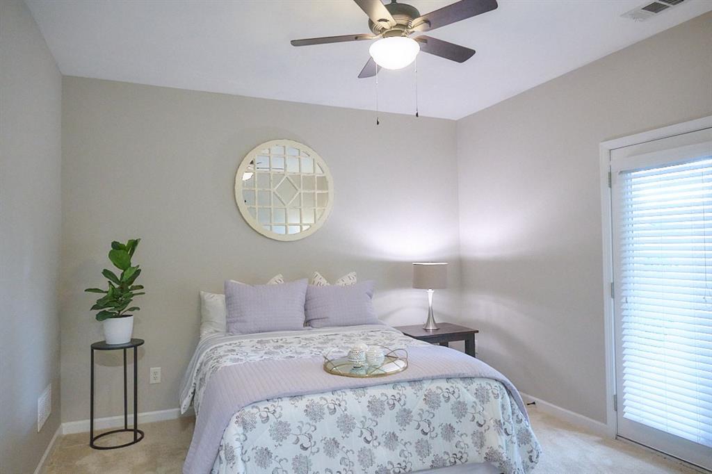 14183 Yacht Terrace Alpharetta, GA 30004 - Photo 27 of 30 a bedroom with a bed and a chandelier