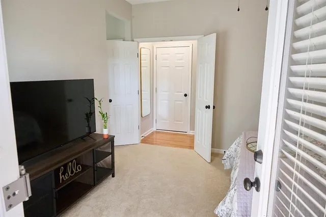 a bathroom with a granite countertop sink mirror vanity and toilet