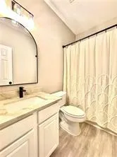 a view of a yard with plants and wooden fence