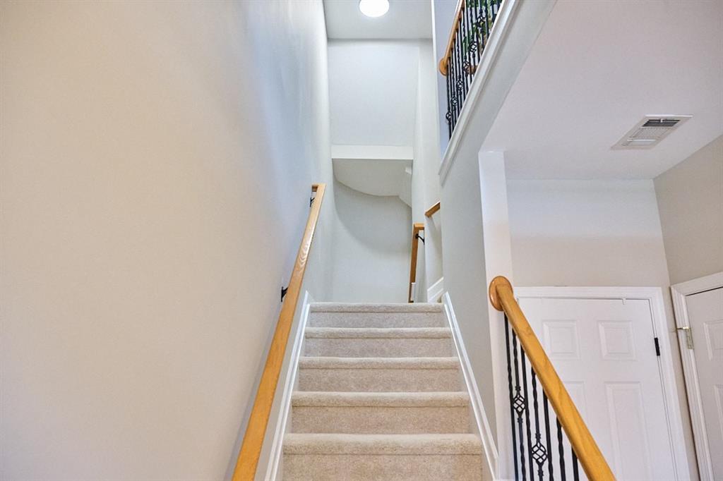 14183 Yacht Terrace Alpharetta, GA 30004 - Photo 6 of 30 a view of staircase with lots of frames on wall and stairs