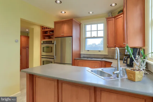 a kitchen with a table chairs and a sink