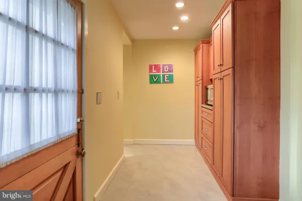 a view of a hallway with wooden floor and stairs