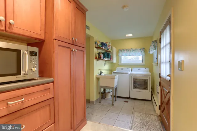 a living room with furniture a large window and glass table