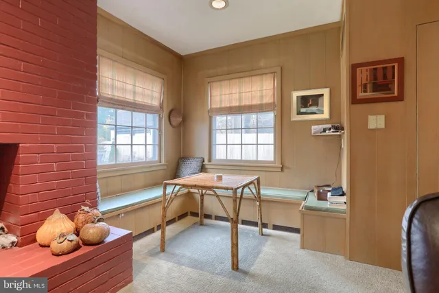 a bedroom with a bed and a lamp on dresser