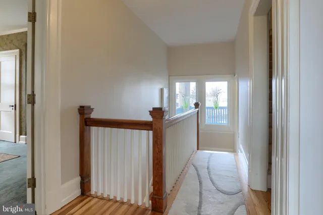 a bedroom with a bed and a dresser next to a window