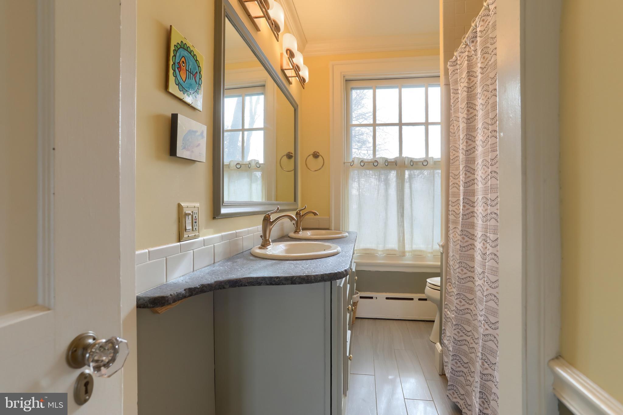 3 East High Street Lebanon, PA 17042 - Photo 33 of 55 a bathroom with a granite countertop sink a toilet and a mirror