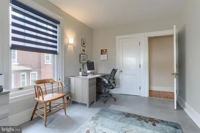 a bedroom with a bed dresser and mirror