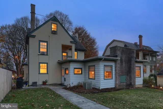 a view of a house with backyard sitting area and garden