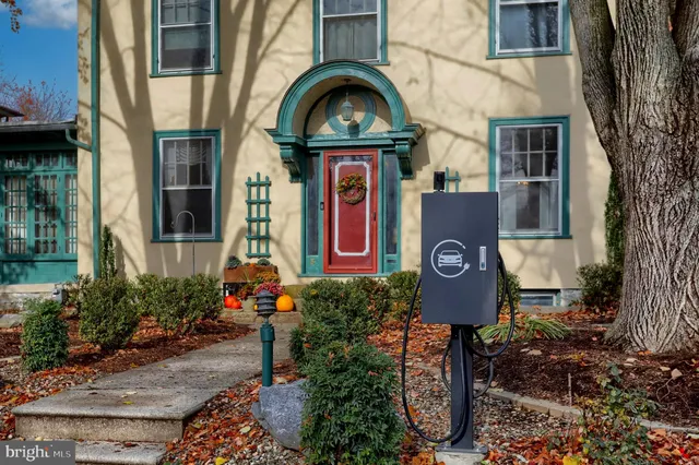 a view of a hallway to a livingroom with furniture