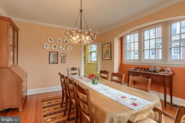 a dining room with furniture and chandelier kitchen view