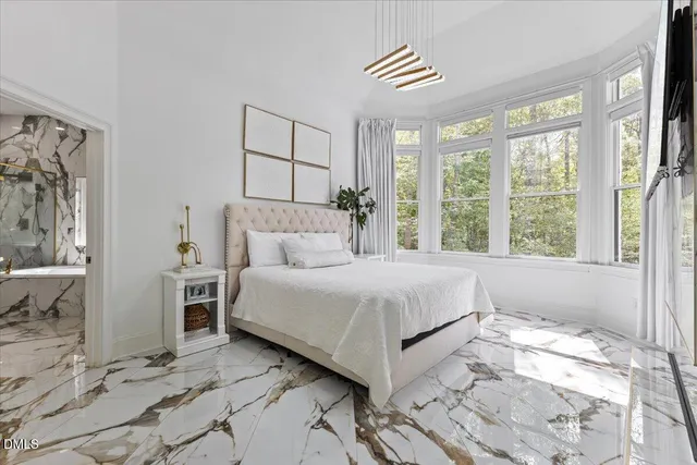 a bedroom with a large bed and a window