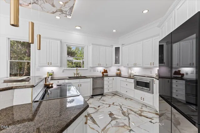 a kitchen with a stove sink and microwave