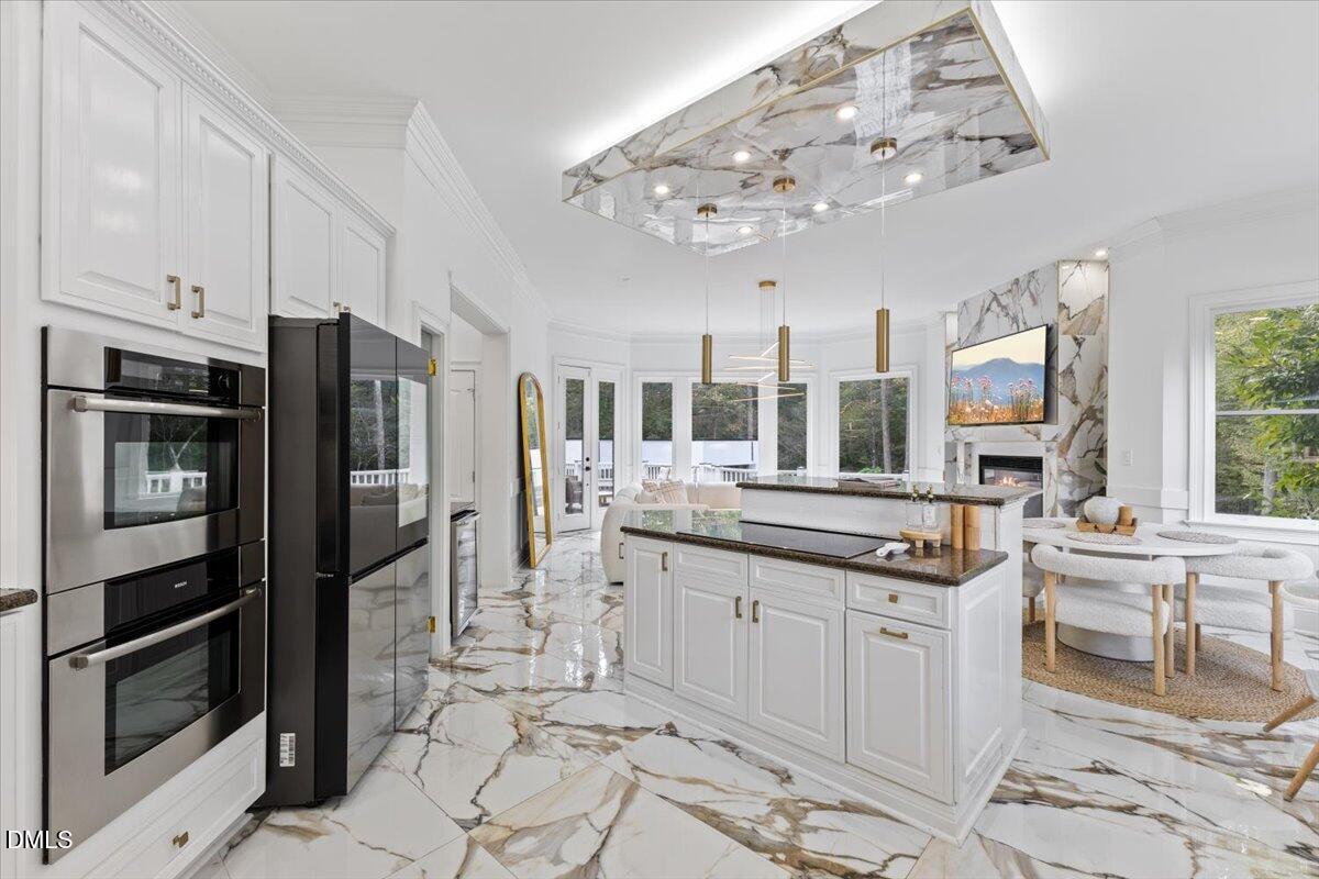 32 Woodgate Court Durham, NC 27713 - Photo 18 of 47 a kitchen with stainless steel appliances a sink stove and refrigerator