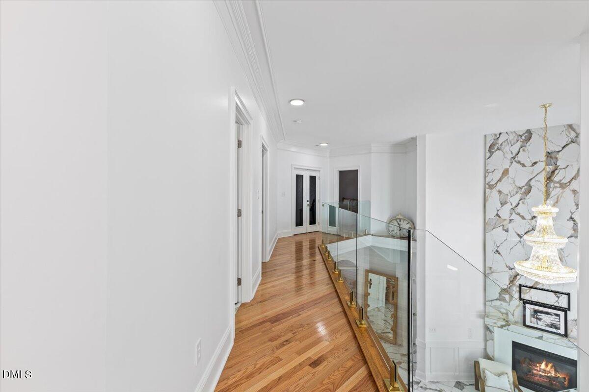32 Woodgate Court Durham, NC 27713 - Photo 23 of 47 a hallway with a couch and wooden floor