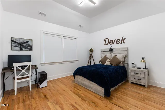 a bedroom with a bed and a desk