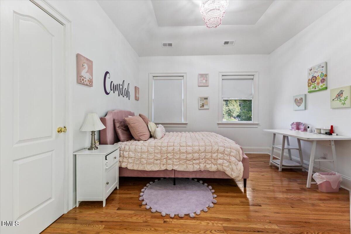 32 Woodgate Court Durham, NC 27713 - Photo 29 of 47 a bedroom with a bed and a table