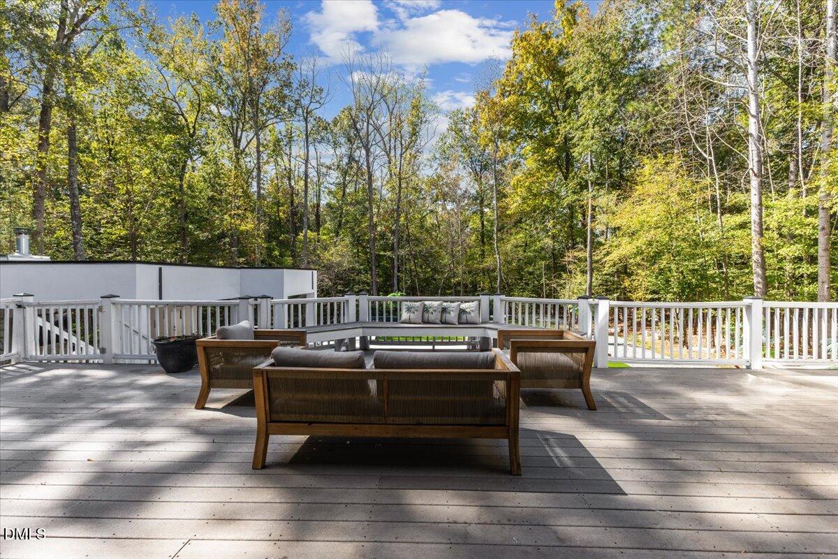 32 Woodgate Court Durham, NC 27713 - Photo 35 of 47 a roof deck with couches and wooden fence
