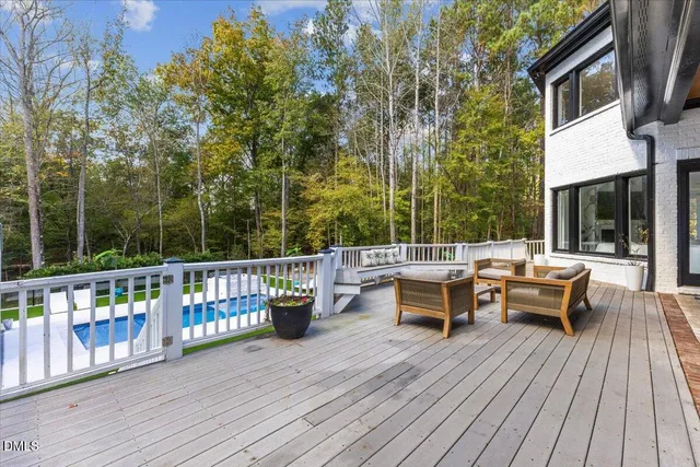 a view of a patio with couches table and chairs and wooden floor
