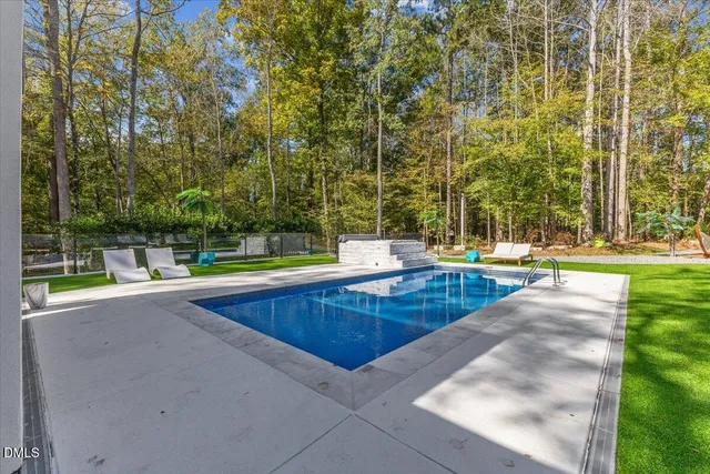 swimming pool view with a outdoor seating