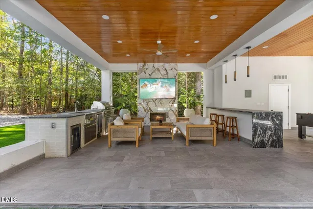 a living room with patio furniture and a large window