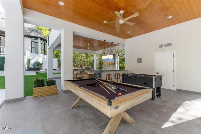 a living room with furniture a ceiling fan and a rug
