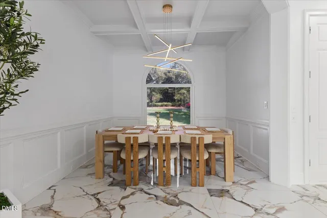 a view of a dining room with furniture and chandelier