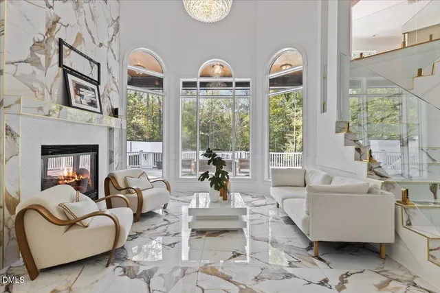 a living room with furniture fireplace and a large window