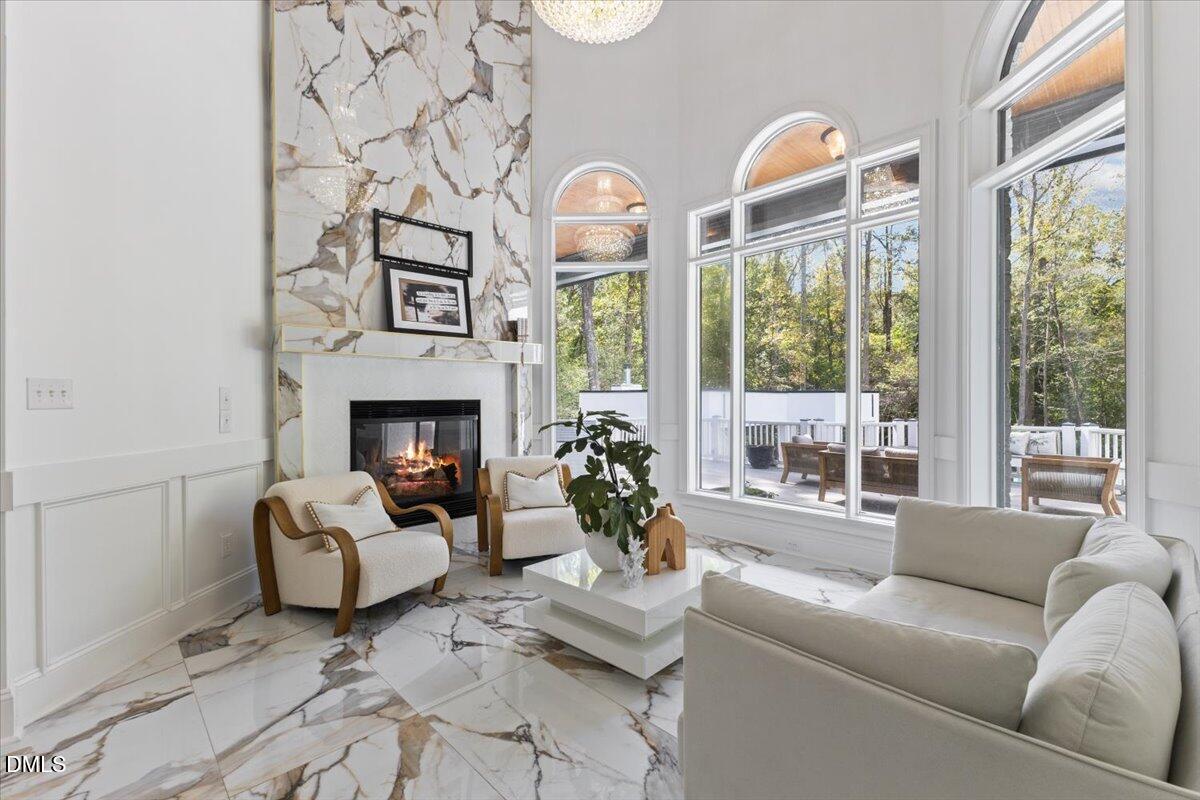32 Woodgate Court Durham, NC 27713 - Photo 7 of 47 a living room with furniture a fireplace and a large window