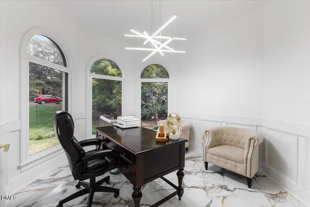 a dining room with furniture a chandelier and a rug