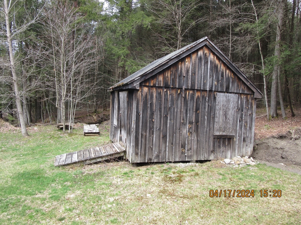 86 Ashfield Road Williamsburg, MA 01096 - Photo 12 of 20 a backyard of a house with wooden fence and large trees