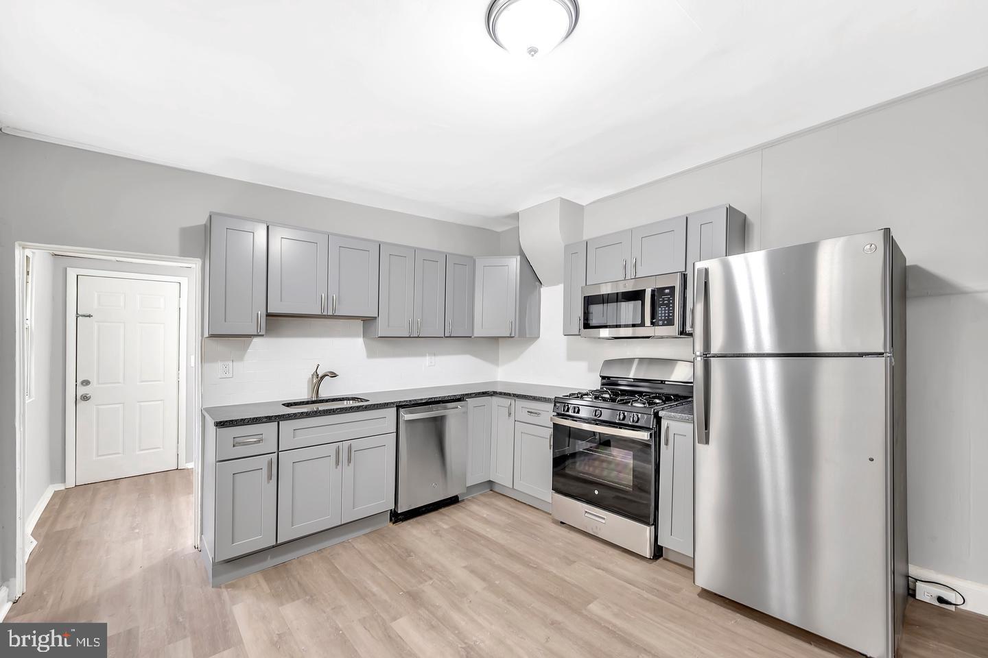 12 Adella Avenue Hamilton, NJ 08609 - Photo 12 of 27 a kitchen with a sink stainless steel appliances and cabinets
