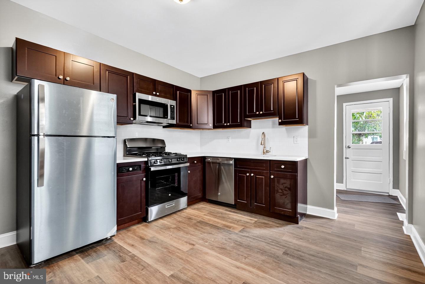 12 Adella Avenue Hamilton, NJ 08609 - Photo 18 of 27 a kitchen with a refrigerator stove and microwave