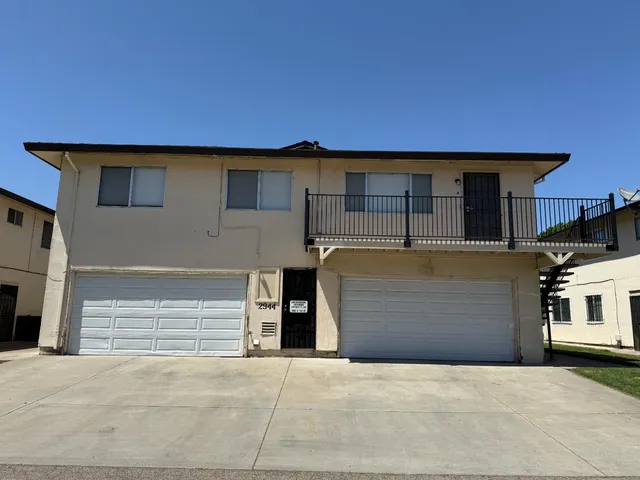 a front view of a house with parking