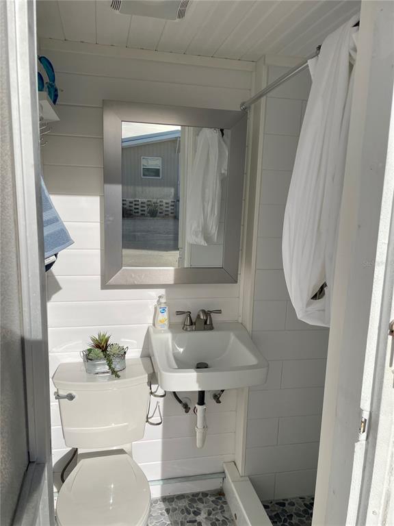 Undisclosed Address Longboat Key, FL 34228 - Photo 13 of 24 a bathroom with a sink toilet and shower