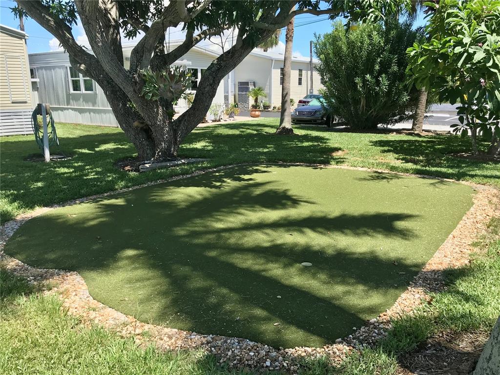 Undisclosed Address Longboat Key, FL 34228 - Photo 17 of 24 a backyard of a house with a garden and plants