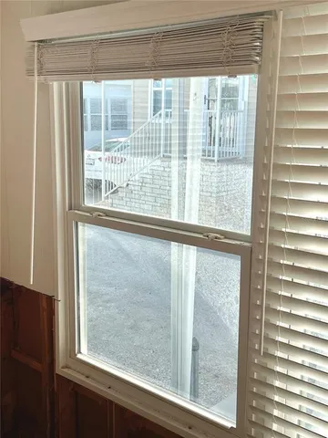 a view of a balcony with furniture and a window