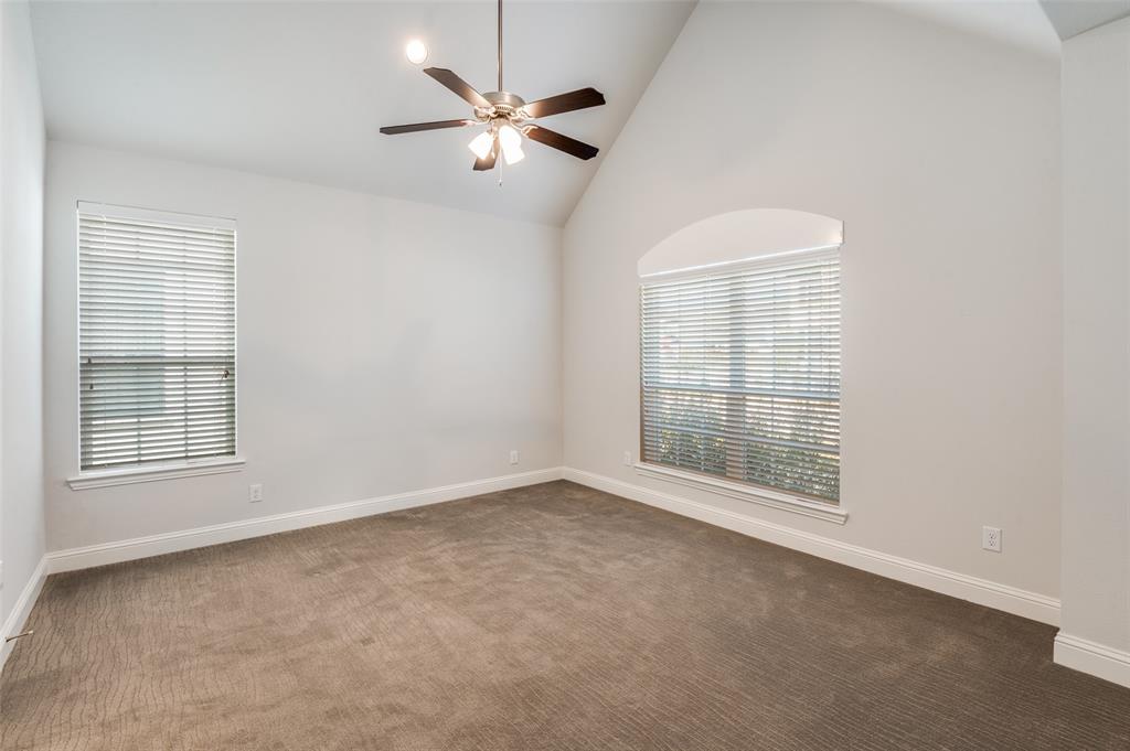 15621 Fringe Tree Road Frisco, TX 75035 - Photo 10 of 18 Unfurnished room with dark colored carpet, high vaulted ceiling, and a ceiling fan