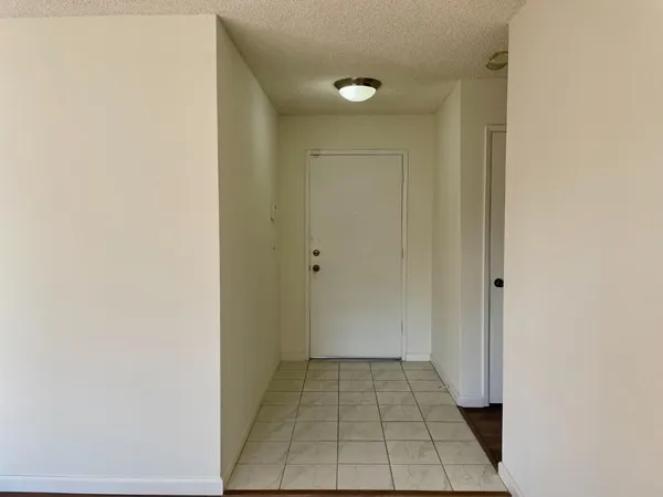 a view of a bedroom with wooden floor and a window