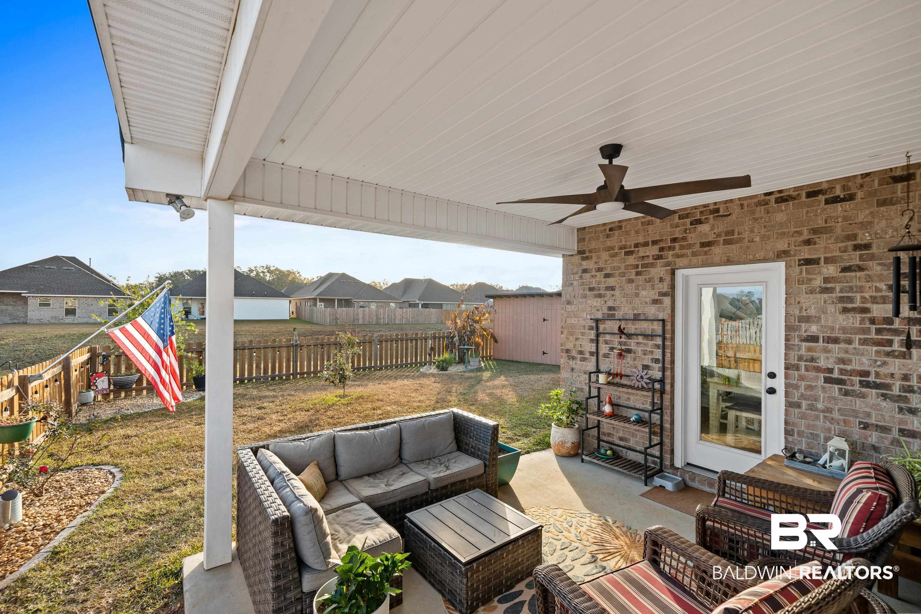 1390 Aldon Street Foley, AL 36535 - Photo 23 of 31 Fenced backyard with ceiling fan, a patio, an outdoor living space, and a residential view